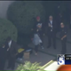 Image of Chris Brown chatting with his lawyer via screengrab/KTLA
